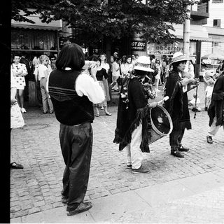 Street musicians performing traditional folk music outdoors.