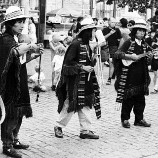 Street musicians performing traditional folk music outdoors.