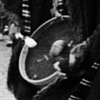 Traditional musicians performing in cultural attire outdoors.