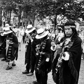 Traditional musicians performing in cultural attire outdoors.