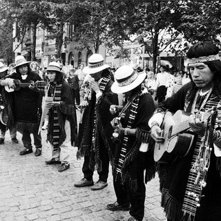 Traditional musicians performing outdoors in cultural attire.