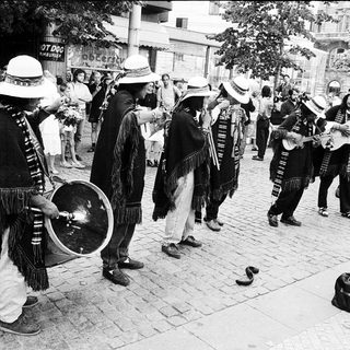 Street musicians performing traditional folk music outdoors.