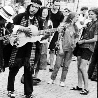 Street musicians performing traditional folk music outdoors.