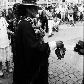 Street musician performing traditional music outdoors.
