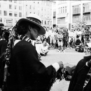 Indigenous cultural performance in urban protest setting.