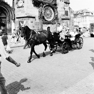 Historic astronomical clock with horse-drawn carriage.