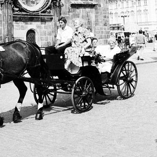 Historic astronomical clock with horse-drawn carriage.