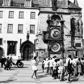 Historic Prague town square with medieval astronomical clock.