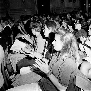 Crowded indoor lecture or event audience listening attentively.