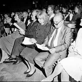 Audience attentively watching an indoor event.