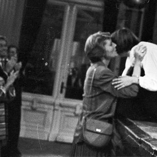 Two people embracing during an emotional indoor scene.
