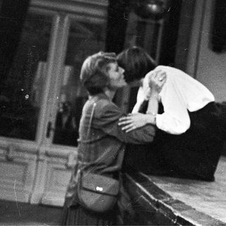Two people embracing during an emotional indoor scene.