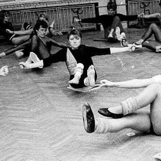 Group stretching exercise in dance studio.