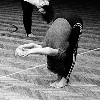 People practicing yoga or stretching indoors.