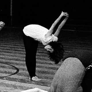 People practicing yoga or stretching indoors.