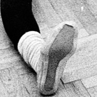 Group performing floor exercises in dance studio.