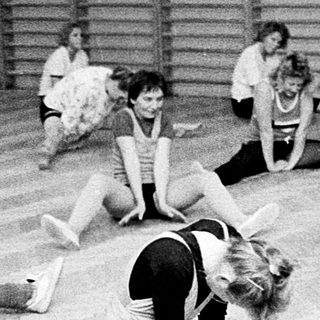 Group of women stretching during dance or gym class.