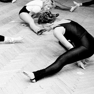 Group of women stretching during dance or gym class.
