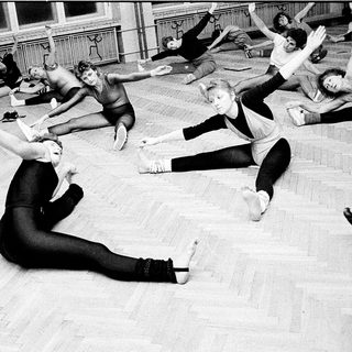 Dance class in progress with floor exercises.