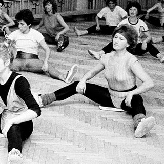 Group dance class with students stretching and practicing.