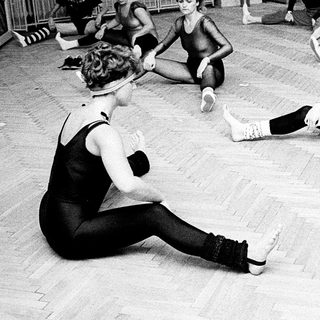 Group dance class with students stretching and practicing.