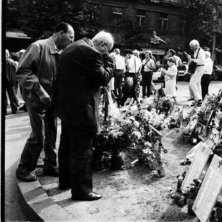 People paying respects at war memorial.