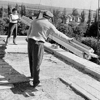 Manual construction of concrete slabs outdoors.
