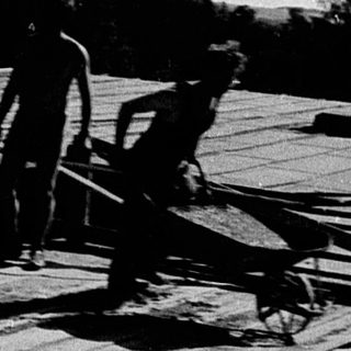 Construction site with workers on elevated platform.