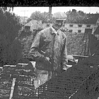 Construction workers on high scaffolding pouring concrete.