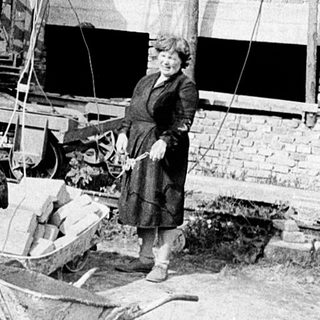 Historic bricklaying and construction workers at site.