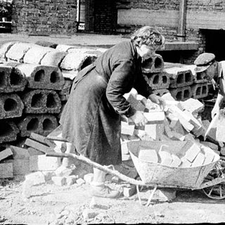 Historic bricklaying and construction workers at site.