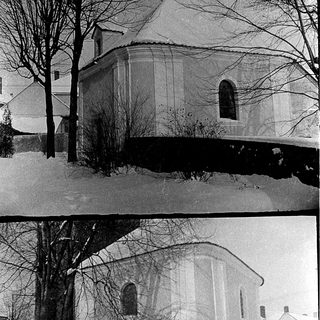 Historic church in snowy winter landscape.
