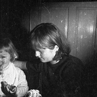 Three children and an adult reacting to something unexpected indoors.