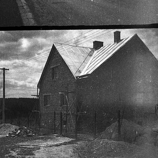 Rural street and buildings in early 20th-century village.