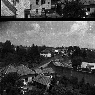 Dense residential area with aged houses before and after restoration.