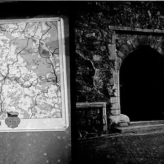 Historic map and ancient stone archway.