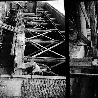 Construction workers assembling large wooden beams.