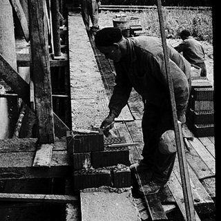 Construction workers assembling large wooden beams.