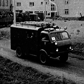 War-damaged buildings and military vehicles.