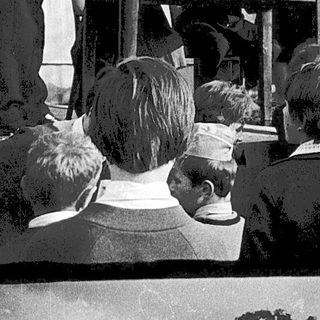 Historic outdoor event with speeches and crowd gathering.