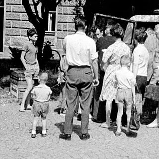 Two childhood scenes: playing outdoors and gathering around a truck.
