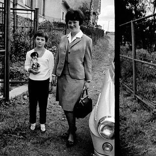 Two women in 1960s-70s attire posing outdoors.
