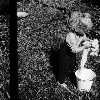 Children scooping grass or soil into buckets.