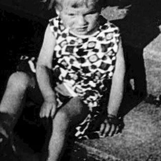 Children and adult at nighttime gravestones.