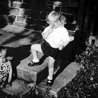 Children and adult at nighttime gravestones.