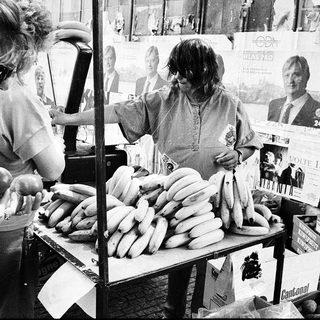 Street vendors selling bananas and sausages.
