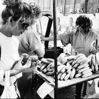 Street vendors selling bananas and sausages.