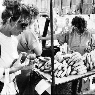 Street vendors selling bananas and sausages.