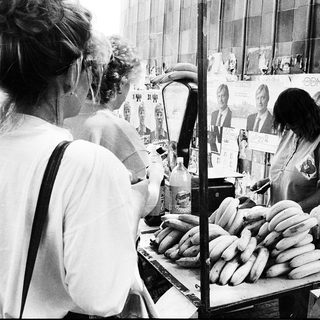 Street vendors selling sausages at outdoor market.