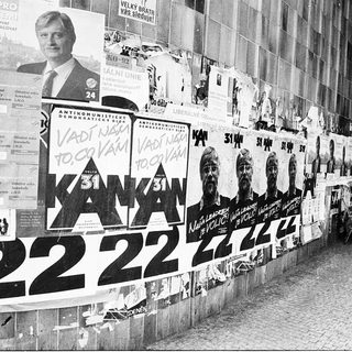 Political campaign posters and anti-communist slogans displayed.